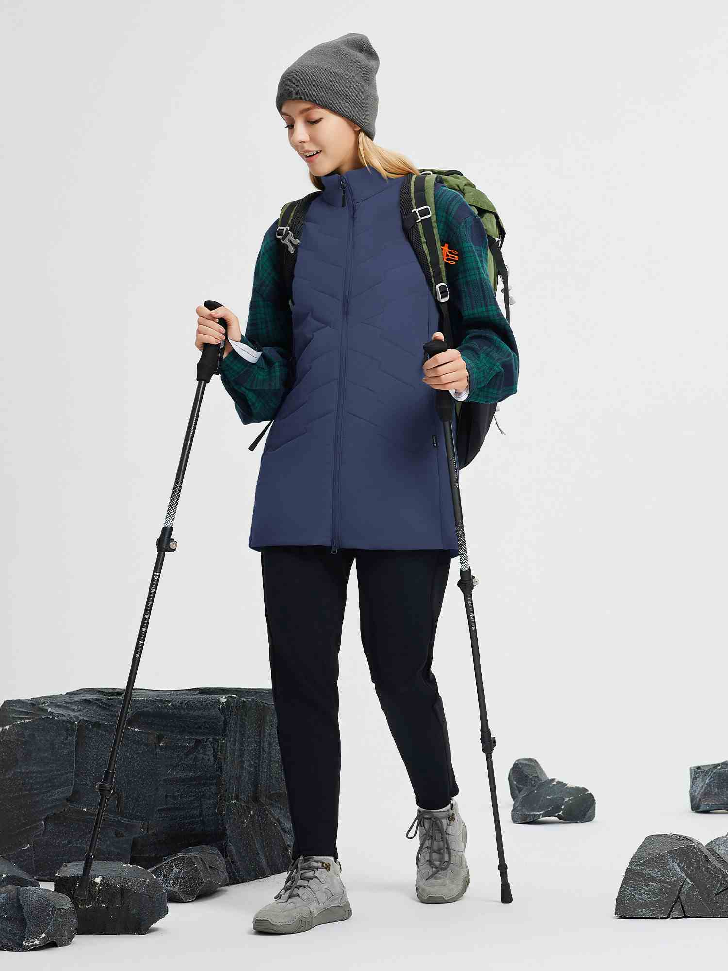 Women's navy quilted mid-length woven hiking vest for outdoor adventures. #color_Navy Blue