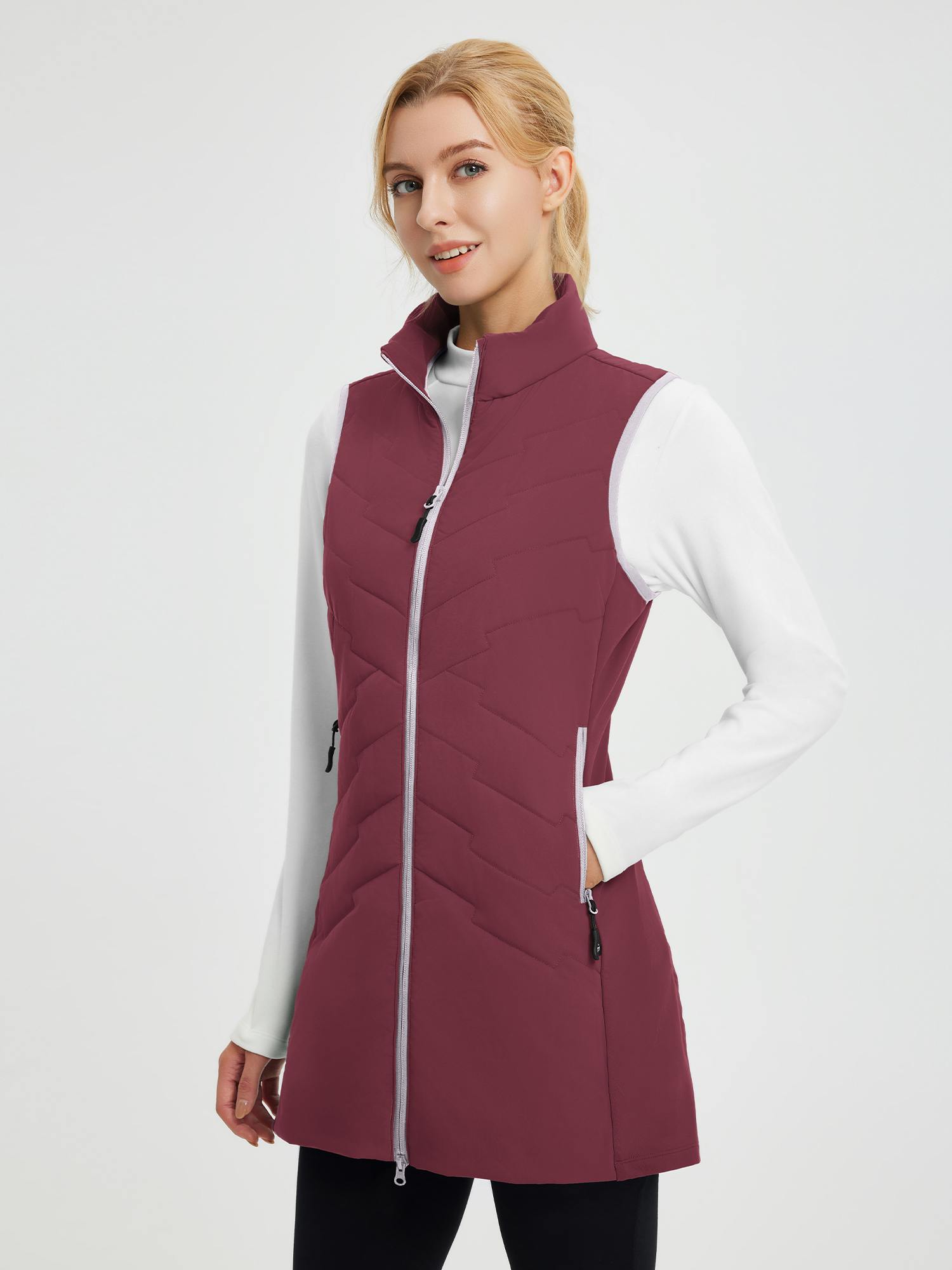 Women's maroon mid-length woven hiking vest, quilted with zipper pockets, for outdoor wear.