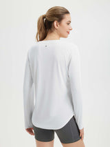 Women's white long sleeve running shirt with curved high-low hem, quick-drying fabric, and reflective back details.