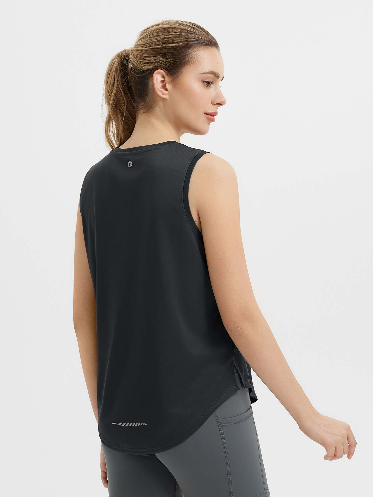 Women's black racerback running tank, curved hem, reflective details. #color_Black