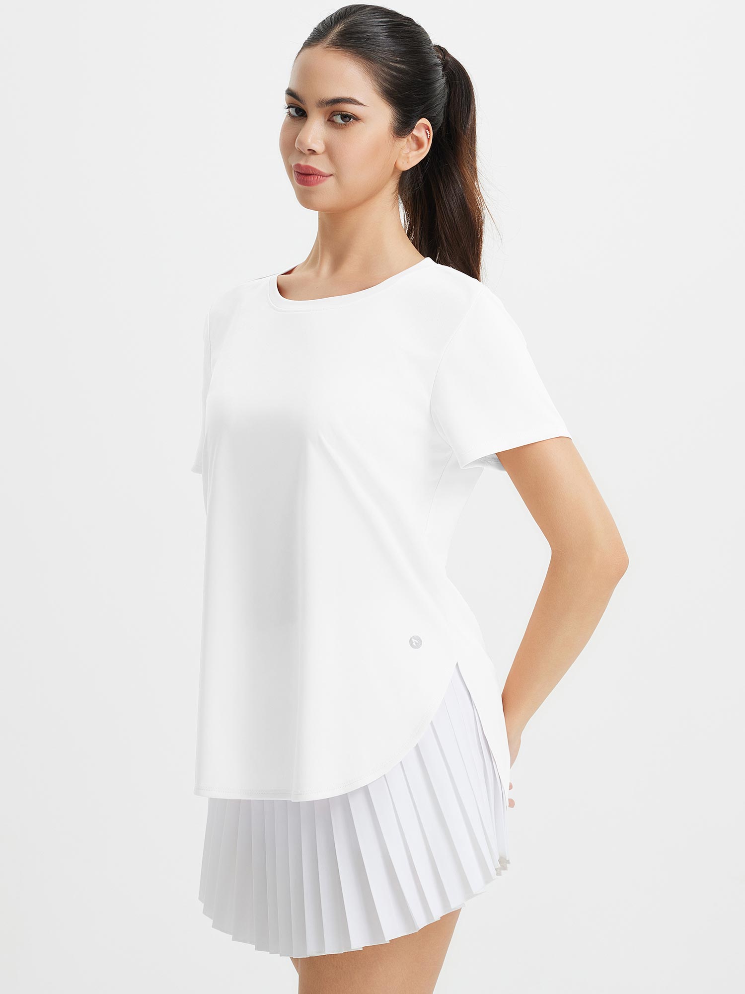 Model in white All-Day Active Set: UPF 50+ tee and pleated shorts for travel/everyday wear. #color_White