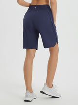 Navy blue women's 9" high-waisted athletic running shorts with curved hem. #color_Navy Blue