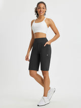 Move-Freely Set: Woman in black 12-inch high-rise shorts with pockets and sports bra. #color_Black