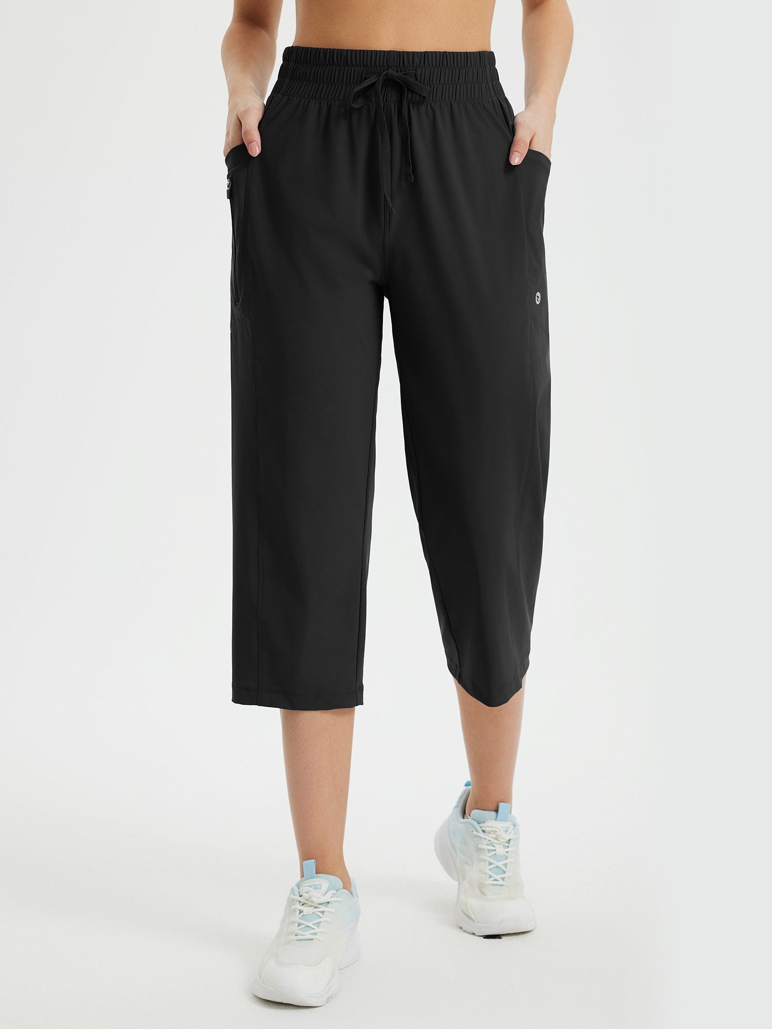 Black women's athletic capris: loose fit, drawstring waist, side & zip pockets. Quick-dry fabric. #color_Black