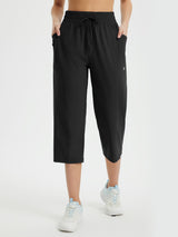 Black women's athletic capris: loose fit, drawstring waist, side & zip pockets. Quick-dry fabric. #color_Black