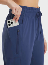Women's navy athletic capris with drawstring waist, side pocket and zippered phone pocket #color_Navy Blue