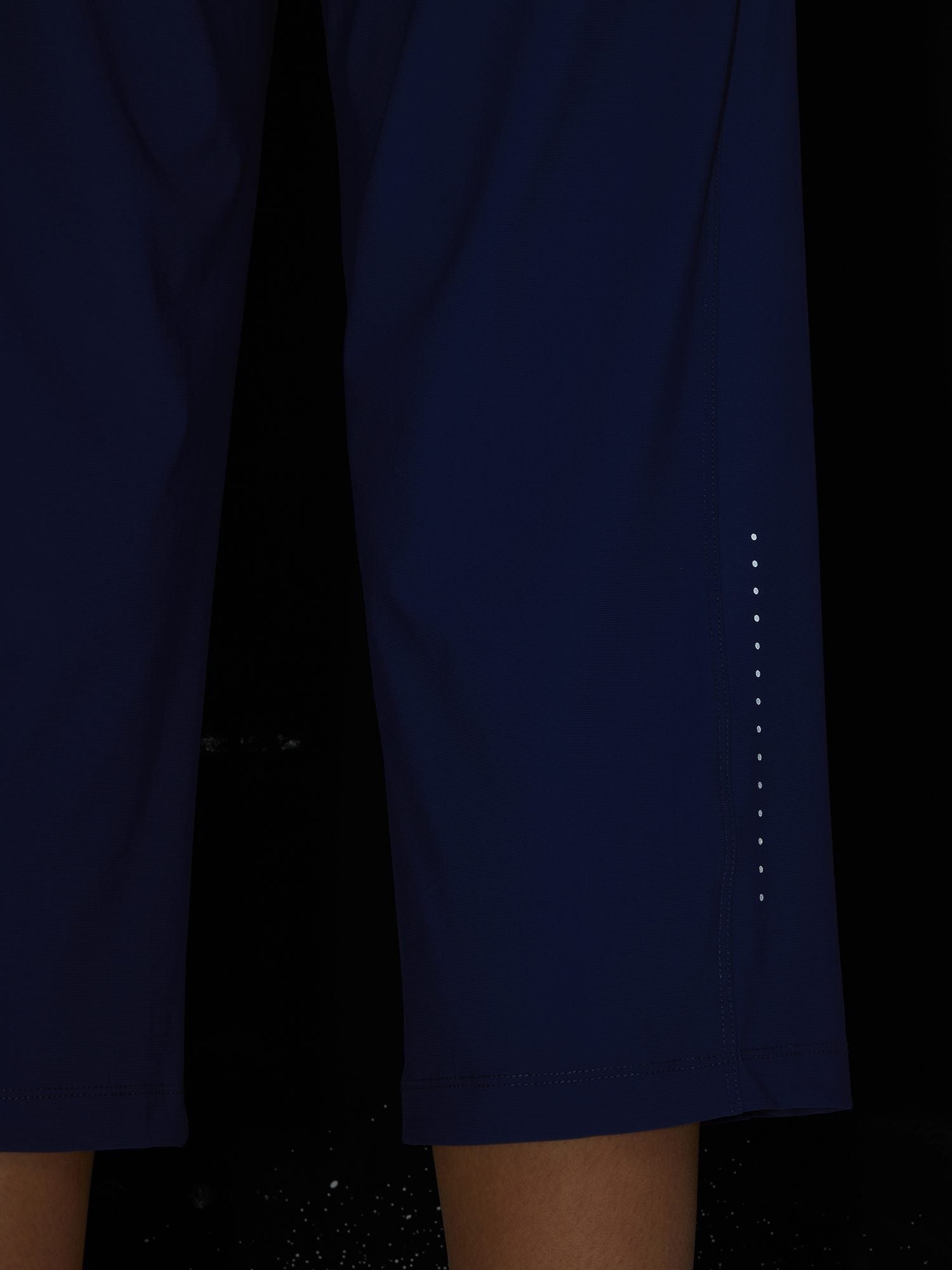 Women's navy athletic capris with reflective dots on the side for visibility. #color_Navy Blue