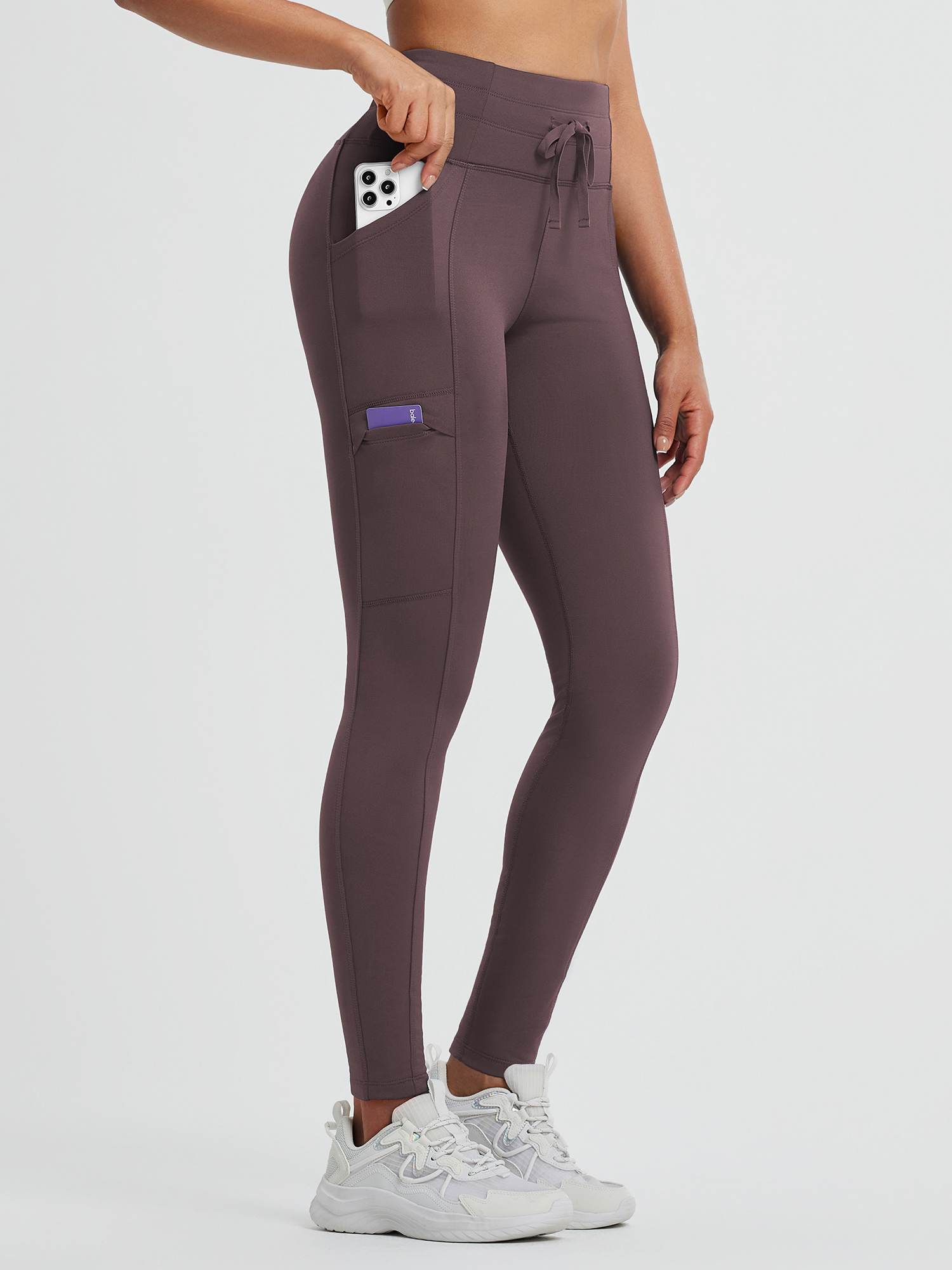 Plum fleece high-waisted running leggings with drawstring and secure pockets.