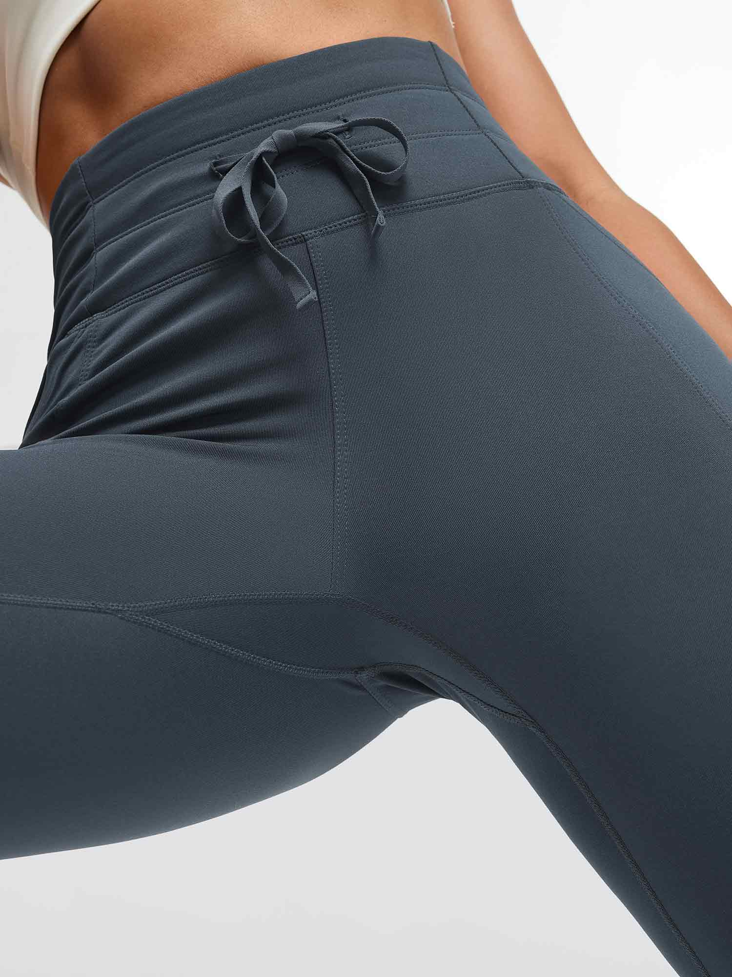 Running high-waisted fleece leggings in charcoal grey with adjustable drawstring and side pockets #color_Charcoal Gray
