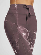 High-waisted running leggings in mauve; water beads off, demonstrating water-resistance.