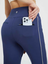 Flat waist fleece-lined running joggers in navy with side stripe & zip pockets. #color_Blue/White