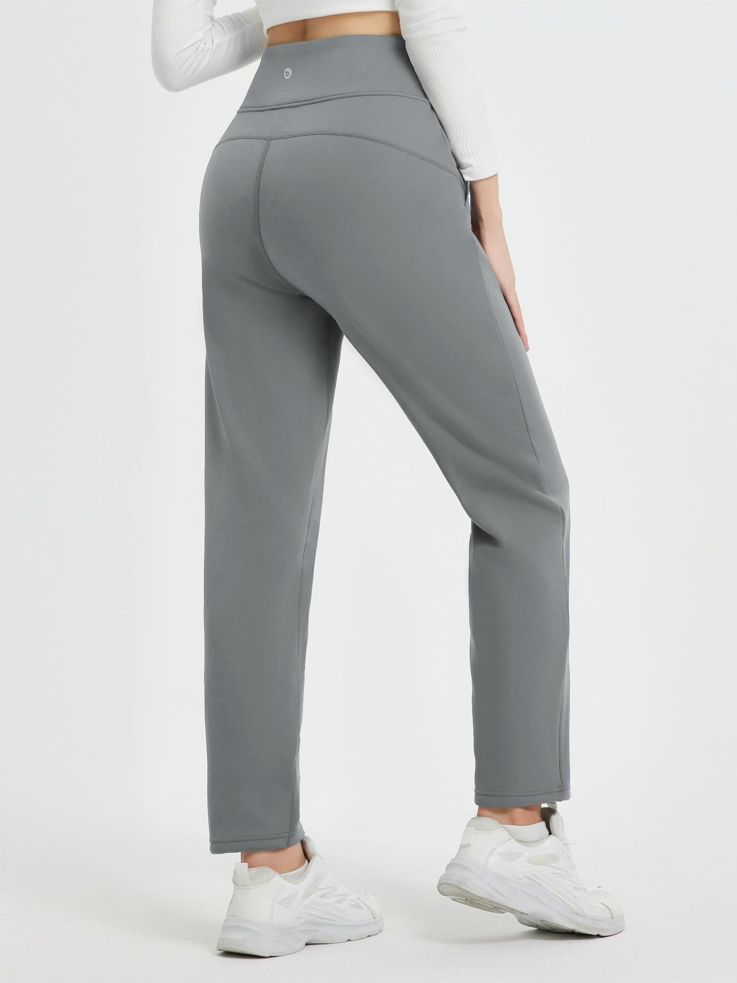 Women's grey heavyweight thermal fleece tapered running pants with high waist, back view.