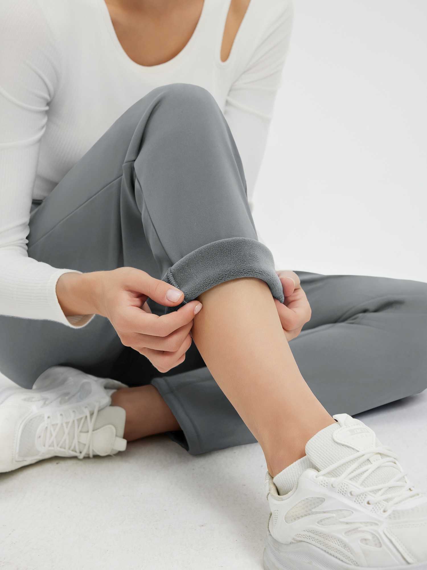 Grey women's heavyweight thermal pants rolled to show thick fleece lining. #color_Dark Gray