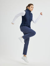 Women's heavyweight navy tapered thermal running pants, puffer vest, active pose. #color_Navy Blue