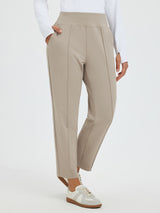 Beige tapered running pants with pouch pockets, high waist, center seam. #color_Teak Brown