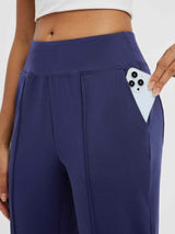 Navy tapered running pants with deep side pocket holding smartphone #color_Navy Blue