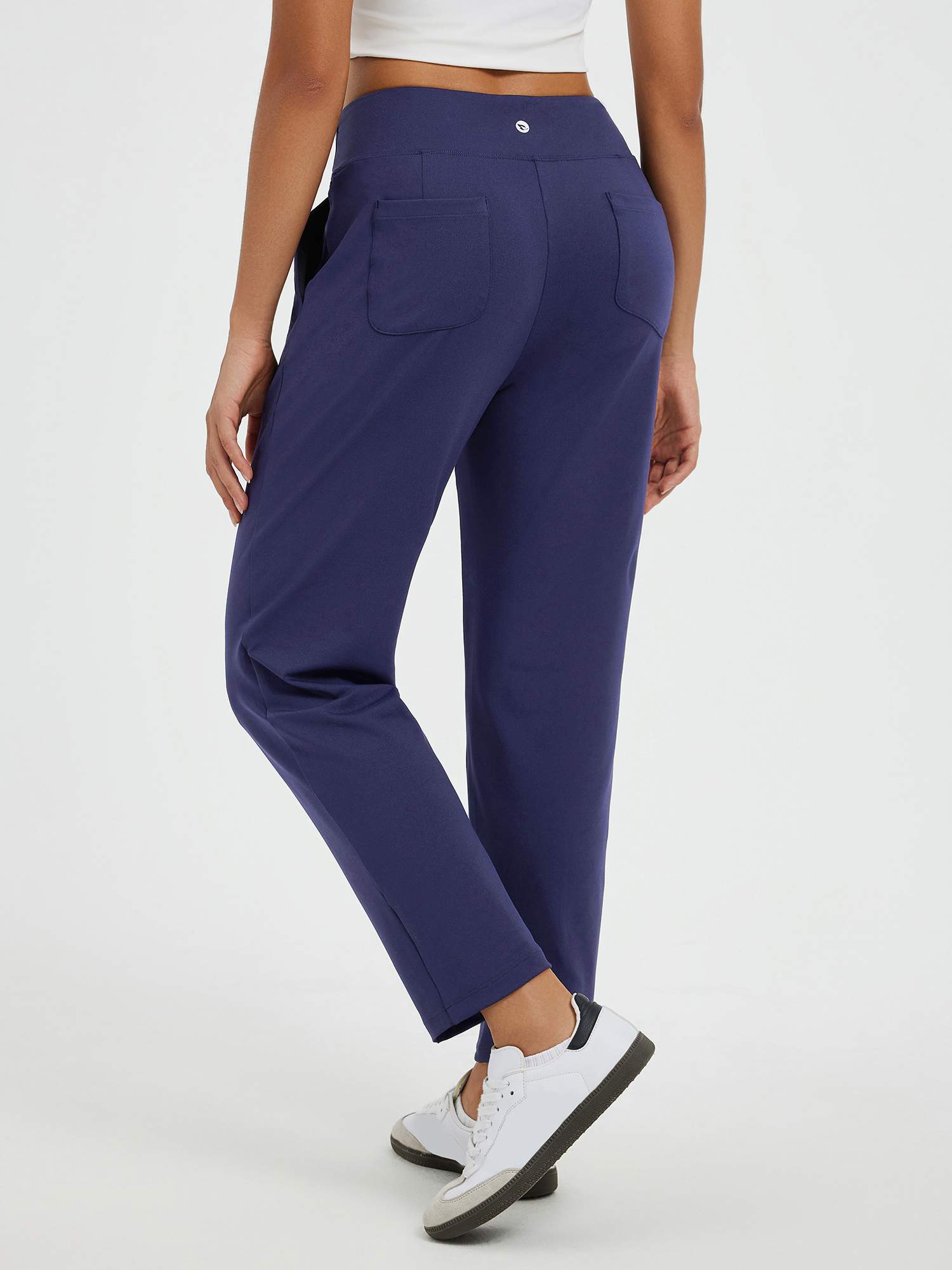 Navy tapered running pants with pouch pockets, back view showing deep, secure pockets. #color_Navy Blue