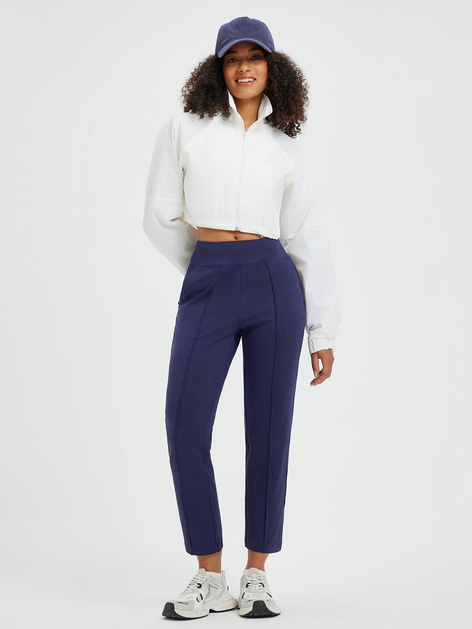 Model wearing navy Tapered Running Pouch Pockets Pants #color_Navy Blue