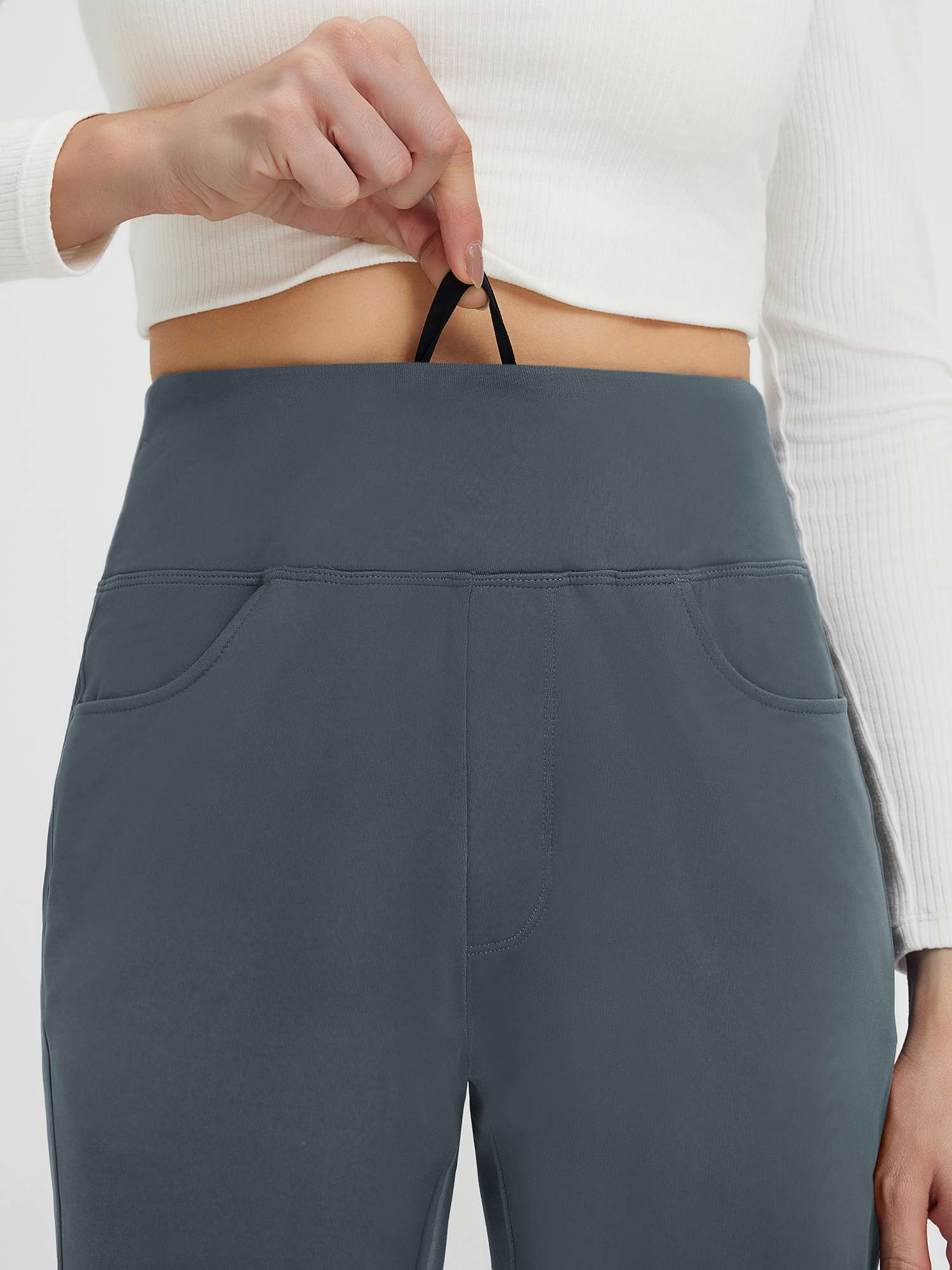 Grey fleece tapered running pants with flat-waist drawstring detail.