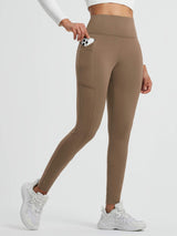 Brown fleece tight running leggings with cross pockets, holding phone. #color_Cocoa Brown