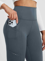 Dark grey fleece running leggings with deep side pocket holding smartphone. #color_Charcoal Gray