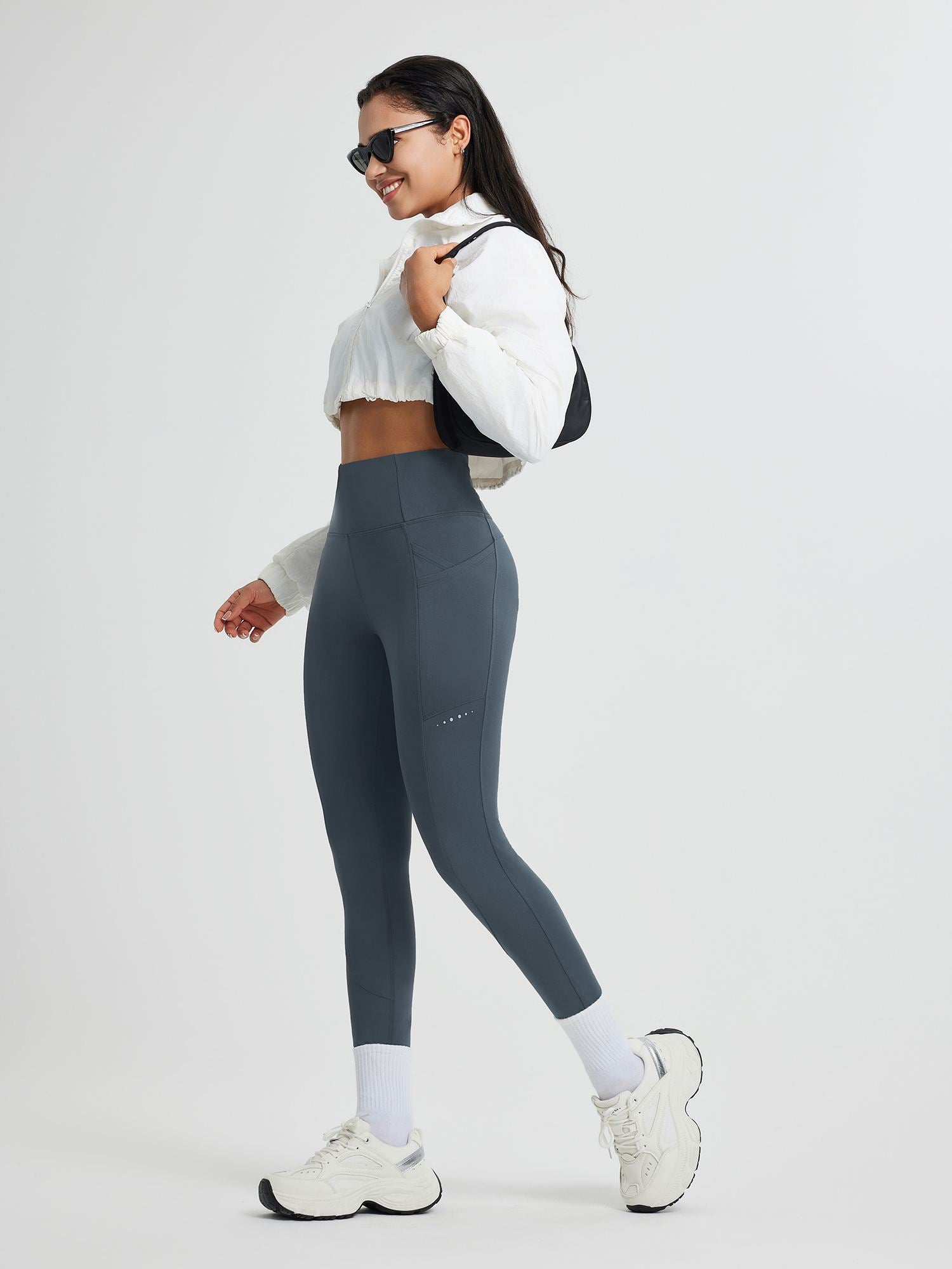 High-waisted charcoal grey fleece running leggings with cross pockets & reflective dots.