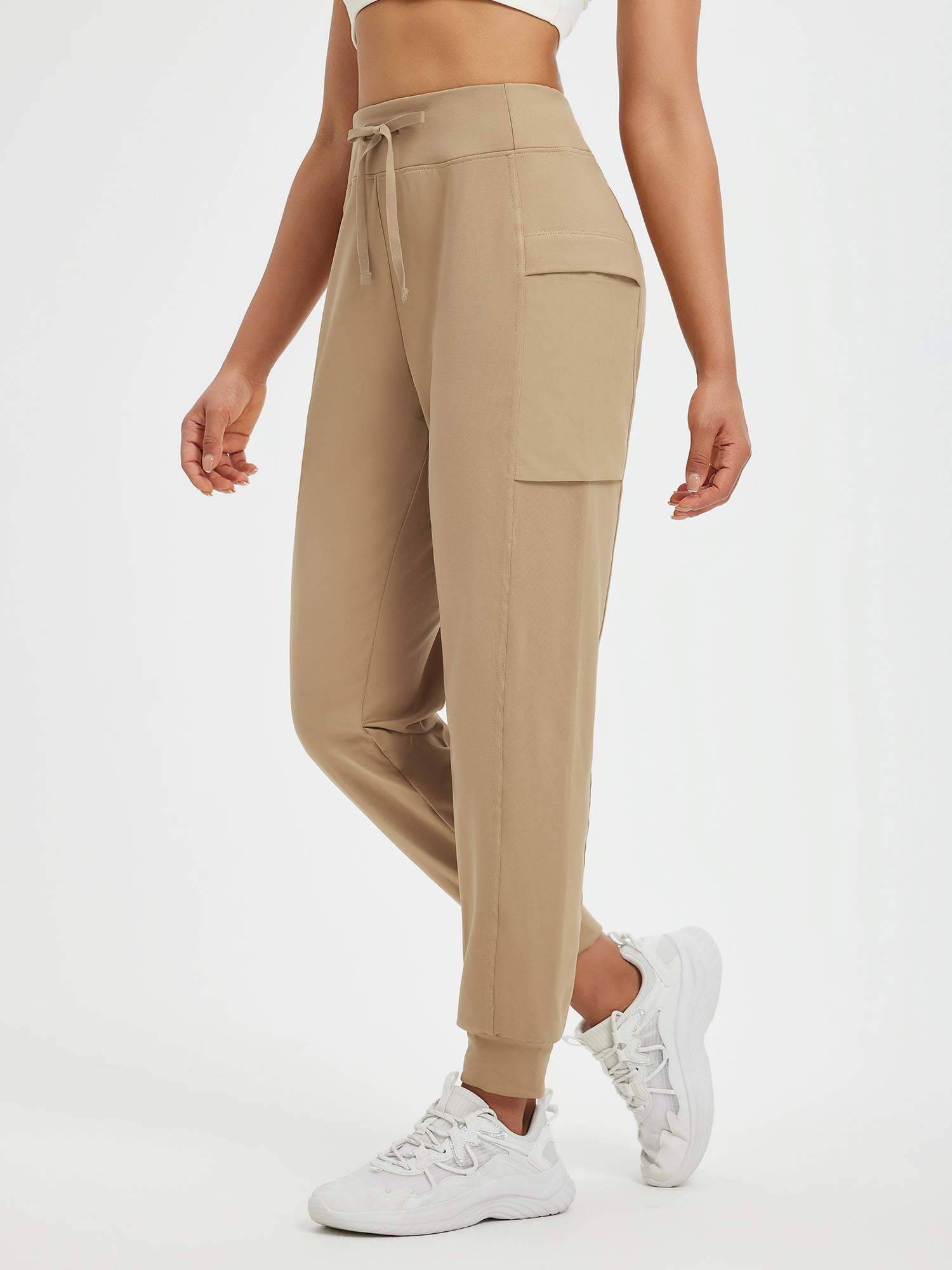 Women's tan fleece cuffed running pants with patchwork pockets and drawstring waist. #color_Tea Brown