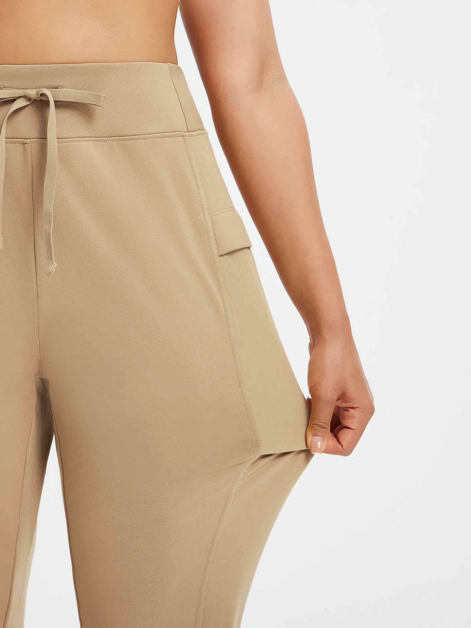 Women's beige running pants: patchwork pocket, drawstring high-rise waist, stretchy fleece. #color_Tea Brown