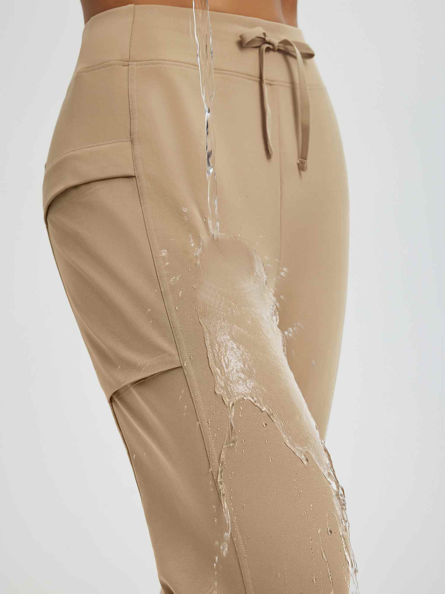 Beige women's fleece running pants with water-repellent patchwork pockets. #color_Tea Brown