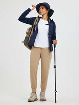 Women's tan fleece cuffed running pants with patchwork pockets, model in outdoor gear. #color_Tea Brown