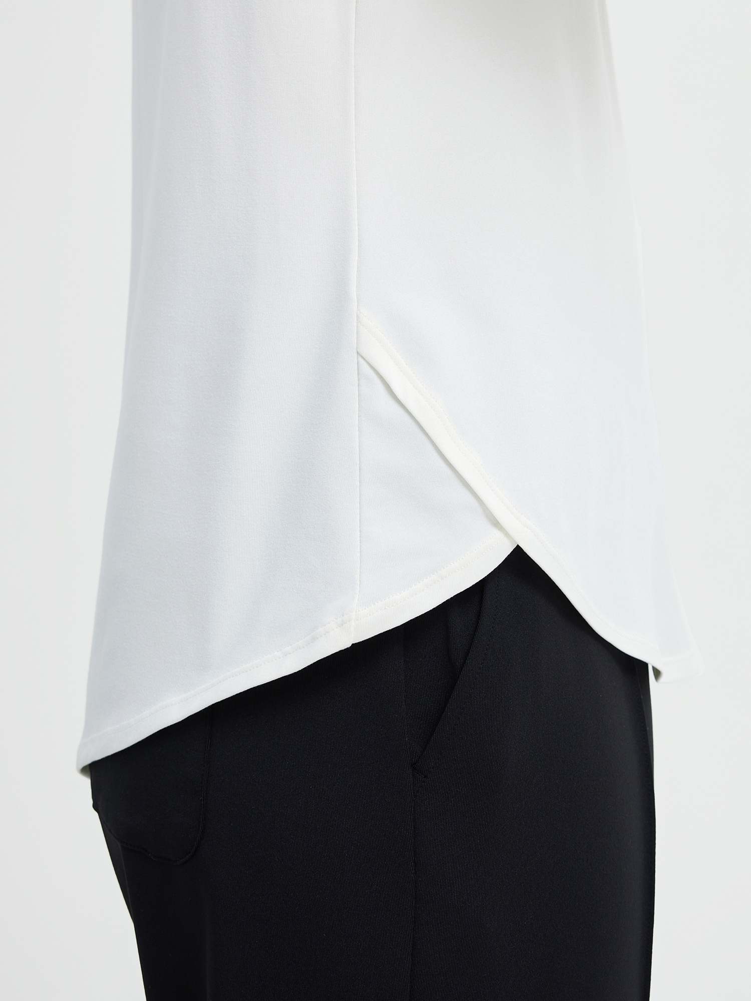 Run-Ready Comfort Set: white long-sleeve running top with cross hem and black high-rise shorts. #color_White