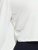White women's long-sleeve running shirt featuring side ruching for a slimming fit. #Color_Star White