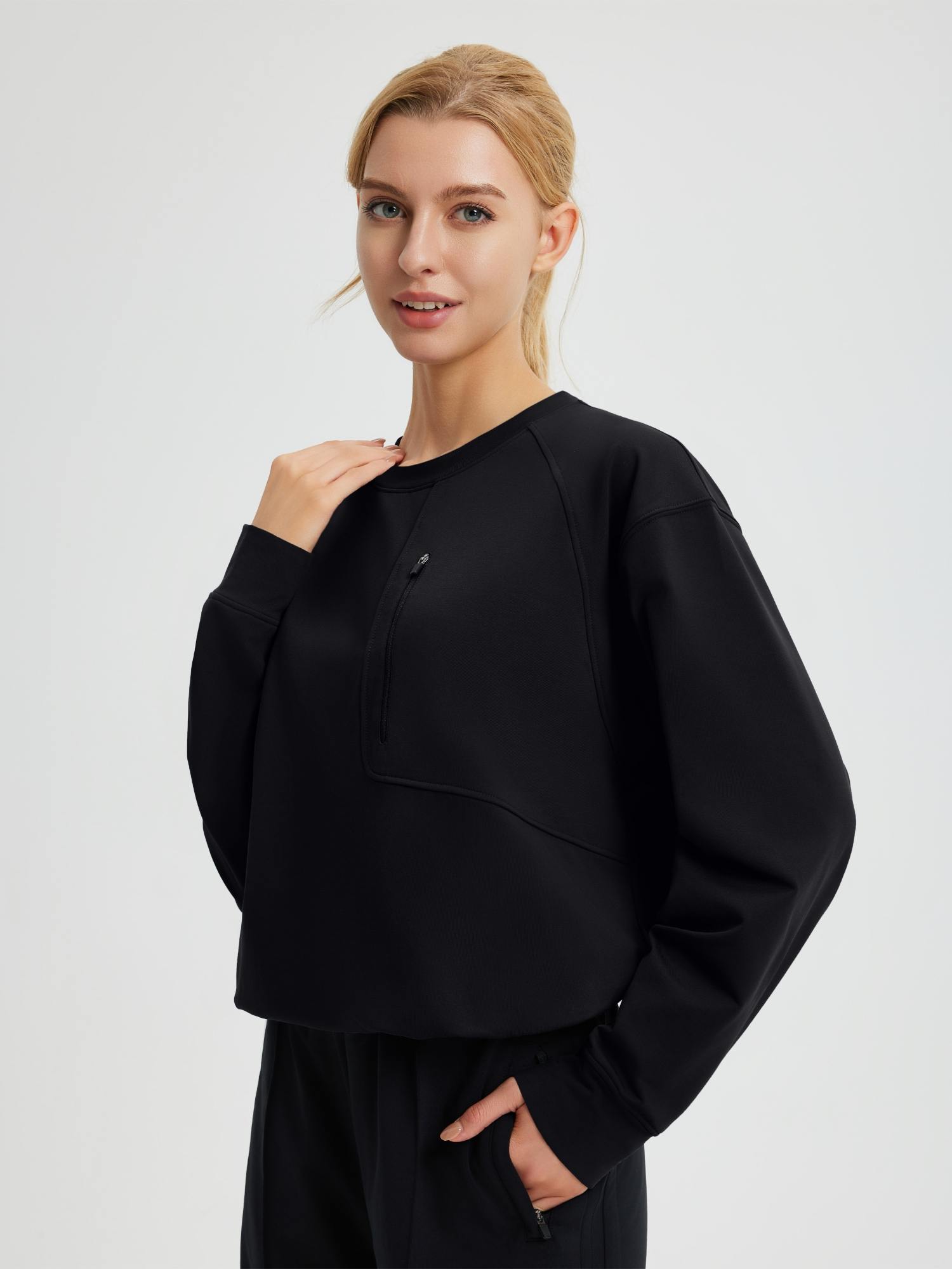 Black raglan fleece long-sleeve running top with zipper chest pocket #color_Black