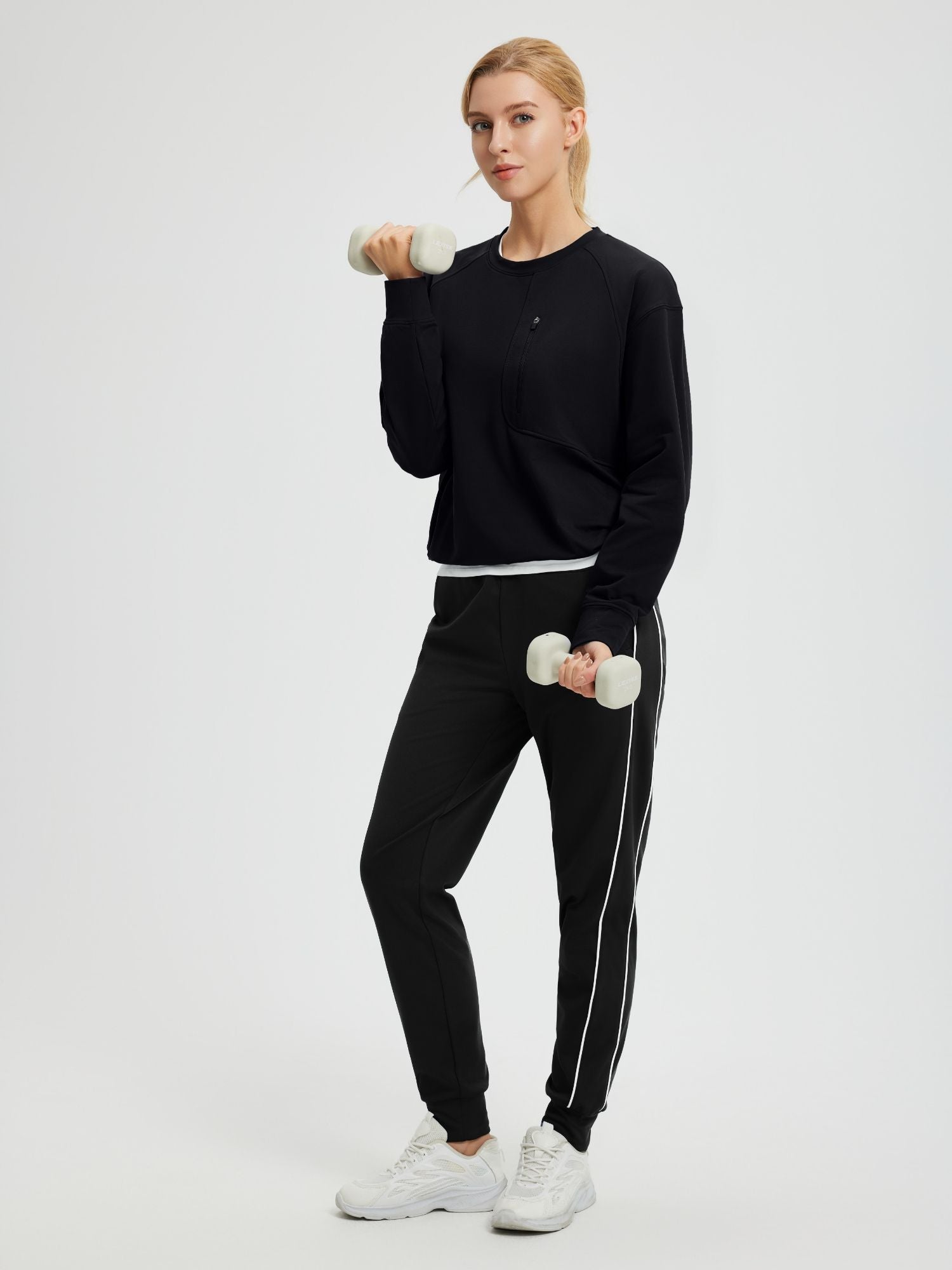 Women's black fleece raglan long-sleeve top with zipper pocket #color_Black