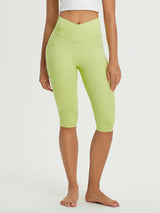 Women's light green 14" high-waisted crossover capri leggings with side pockets. #color_Light Green