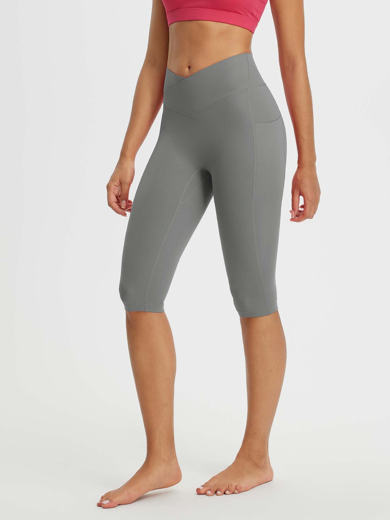 Gray women's 14-inch high-waisted crossover capris with two side pockets and a v-shaped waistband. #color_Dark Gray