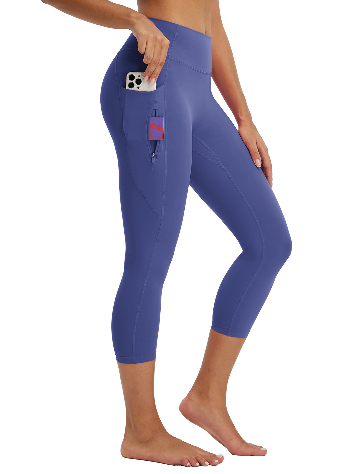 Women's athletic periwinkle blue 21-inch capris, high-waisted with functional side pocket and zipper. #color_Navy Blue
