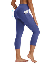 Purple 21" high-waisted capris feature phone pocket, zip pocket, and butt-lifting design.