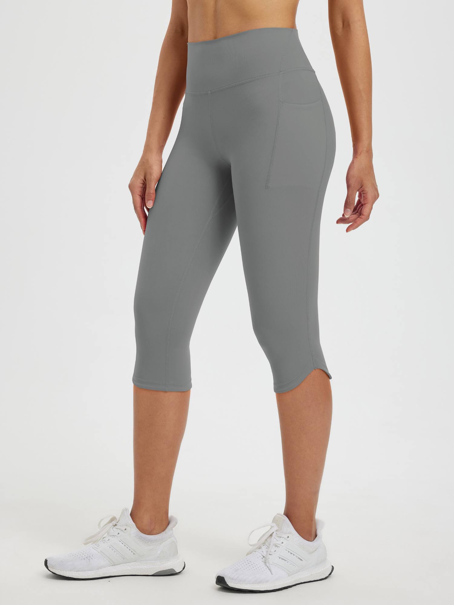 Women's gray high-waisted 17" capri leggings with side pockets and subtle flare hem #color_Dark Gray