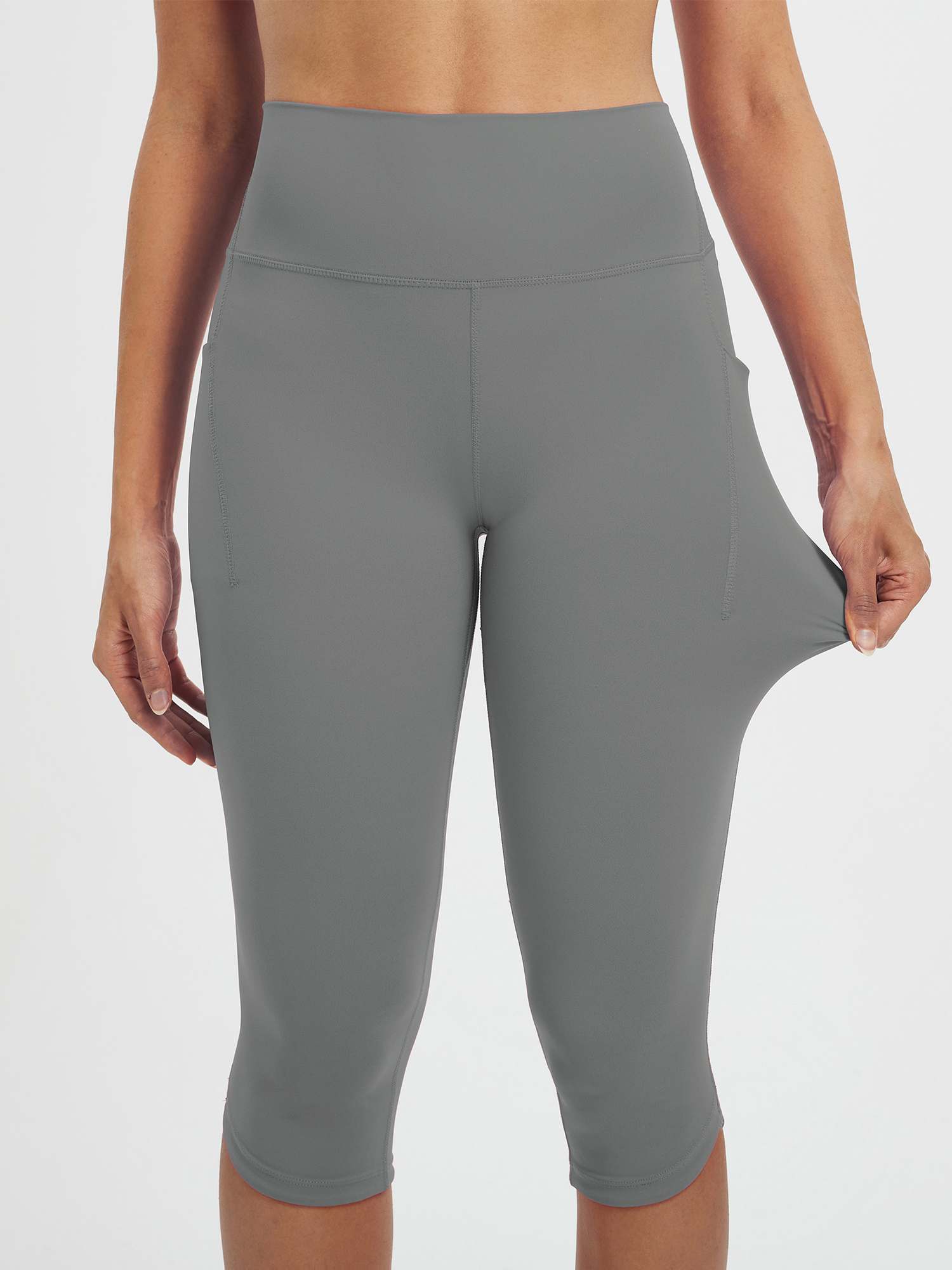 Women's grey 17" high-waisted capris with side pockets, showcasing stretch fabric. #color_Dark Gray