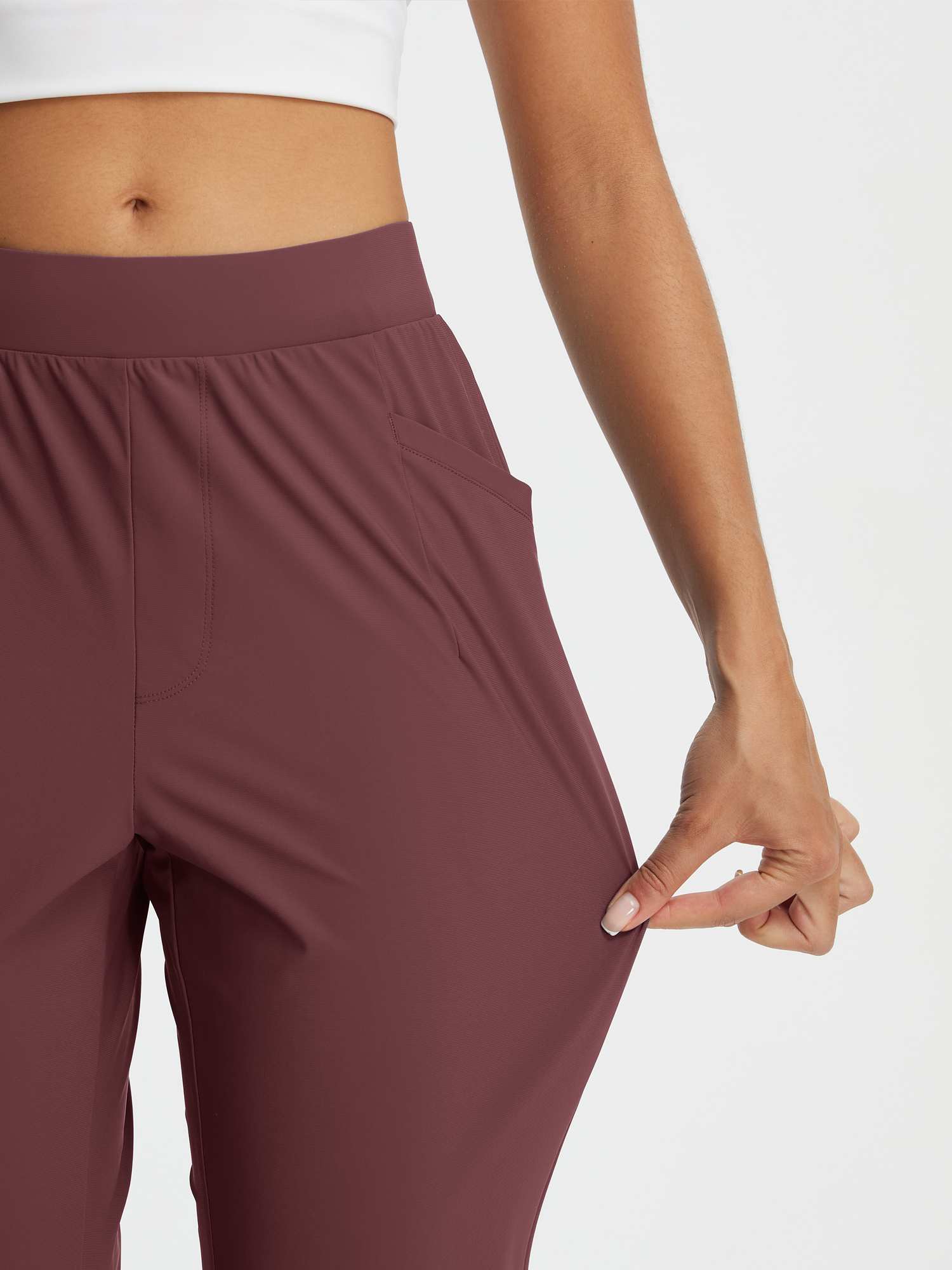 Dynamic Form high-rise tapered trousers in maroon, showcasing stretch fabric. #color_Burgundy