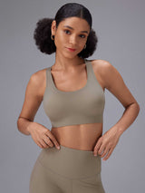 Model in muted taupe yoga comfort set: sports bra and 12-inch high-rise shorts. #color_Brown