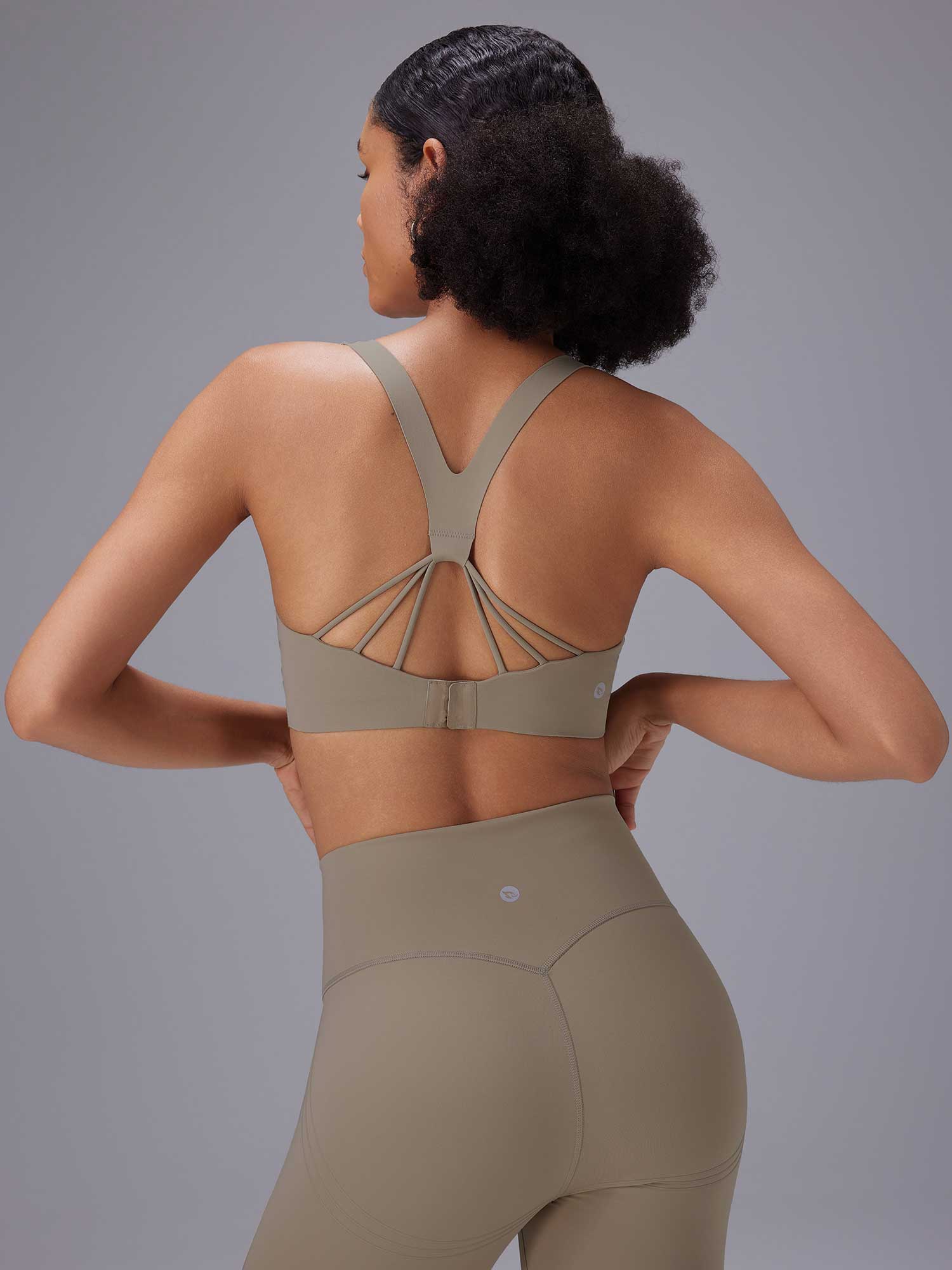 Taupe yoga set: strappy back sports bra and high-rise shorts for comfortable movement. #color_Brown