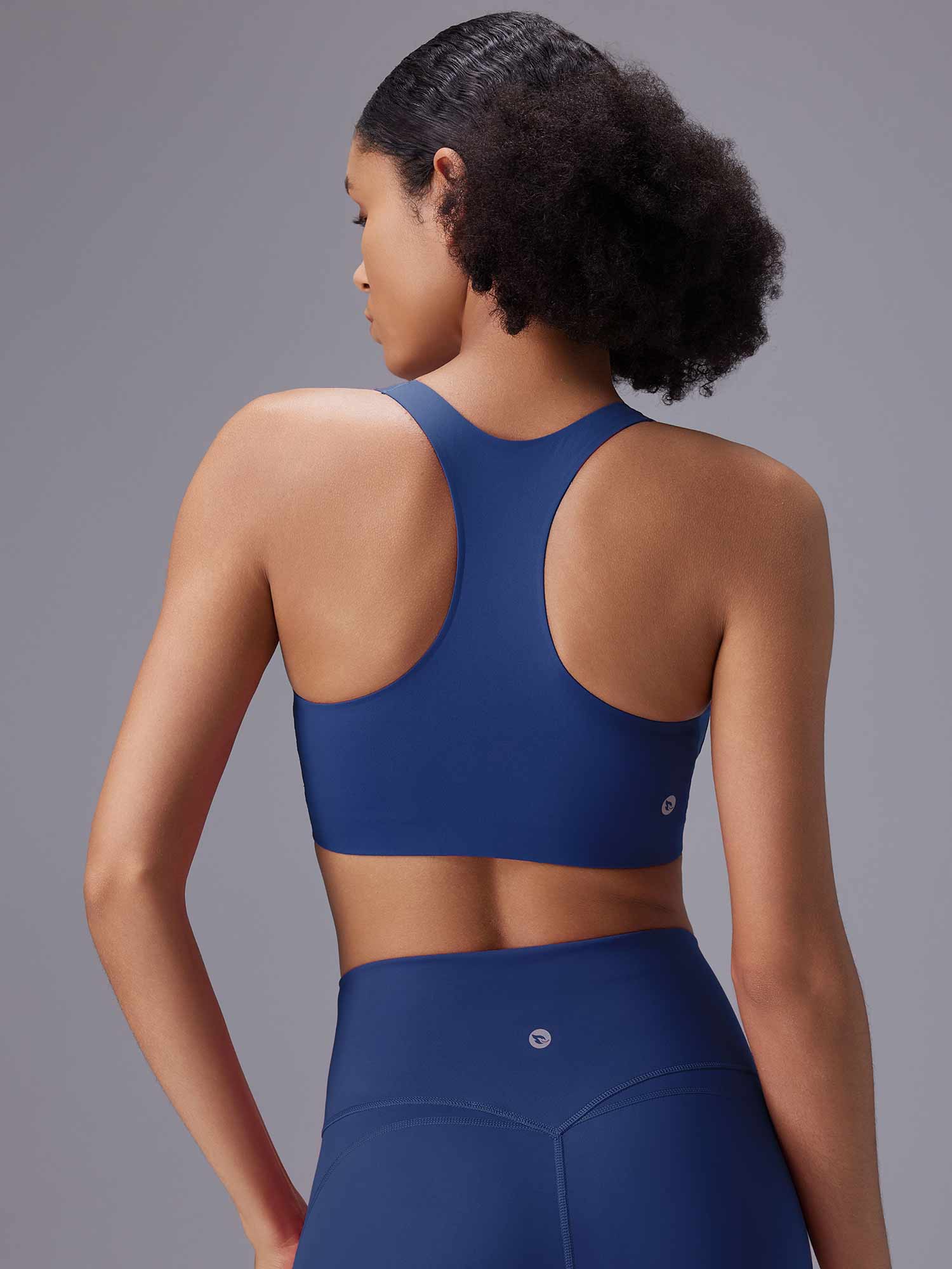 Blue racerback sports bra and high-waisted leggings set for active essentials. #color_Blue