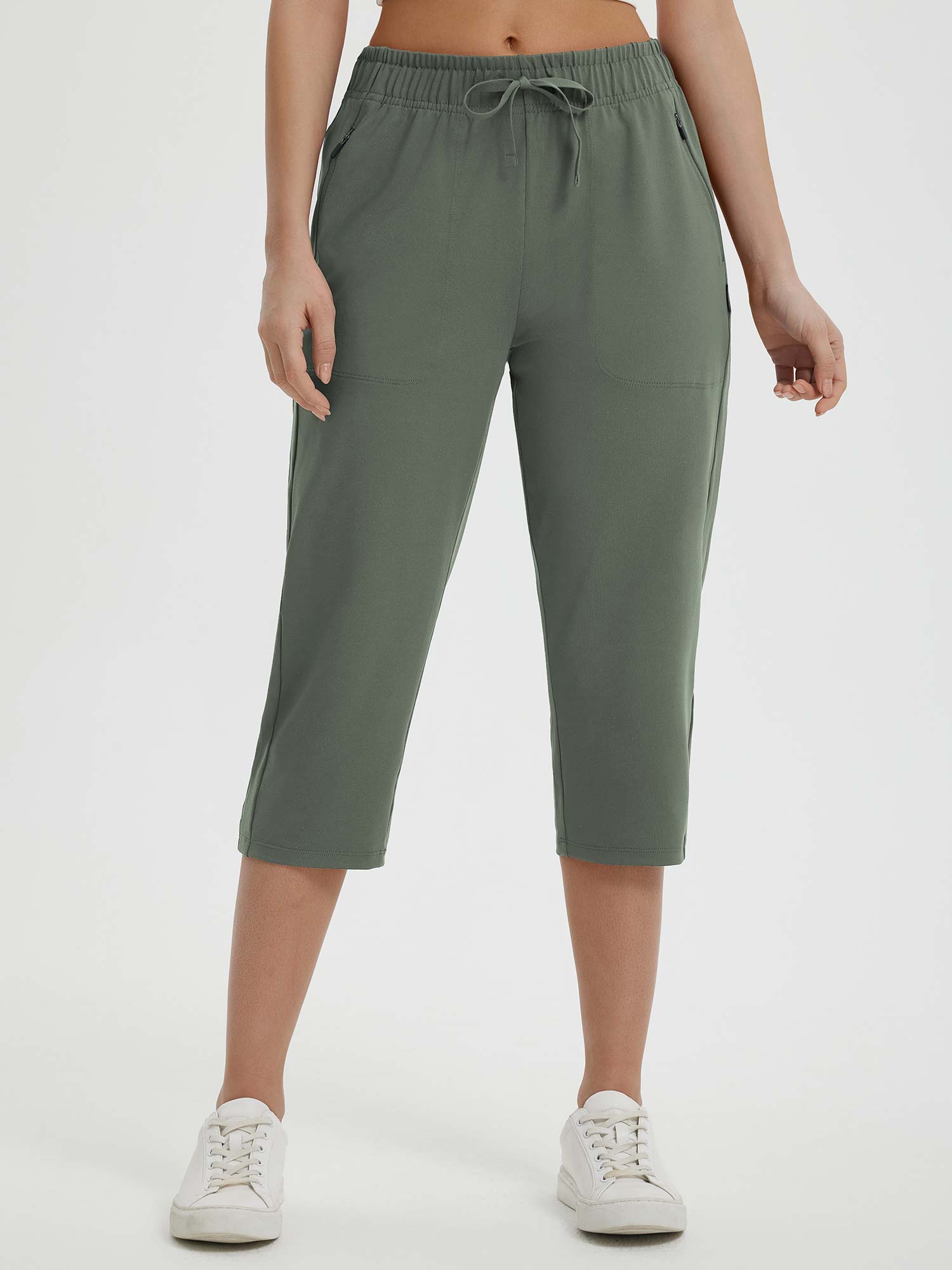 Woman wearing olive green Baleaf 19" quick-dry yoga capri pants with pockets and drawstring. #color_Army Green