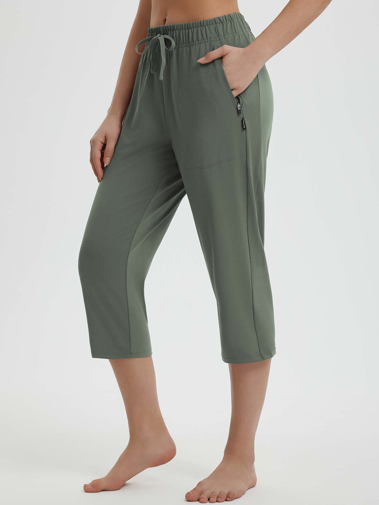 Green women's 19-inch quick-dry yoga capri pants with drawstring and zip pockets. #color_Army Green