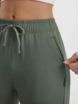 Women's green Baleaf yoga capri pants with drawstring waist and zippered pockets. #color_Army Green