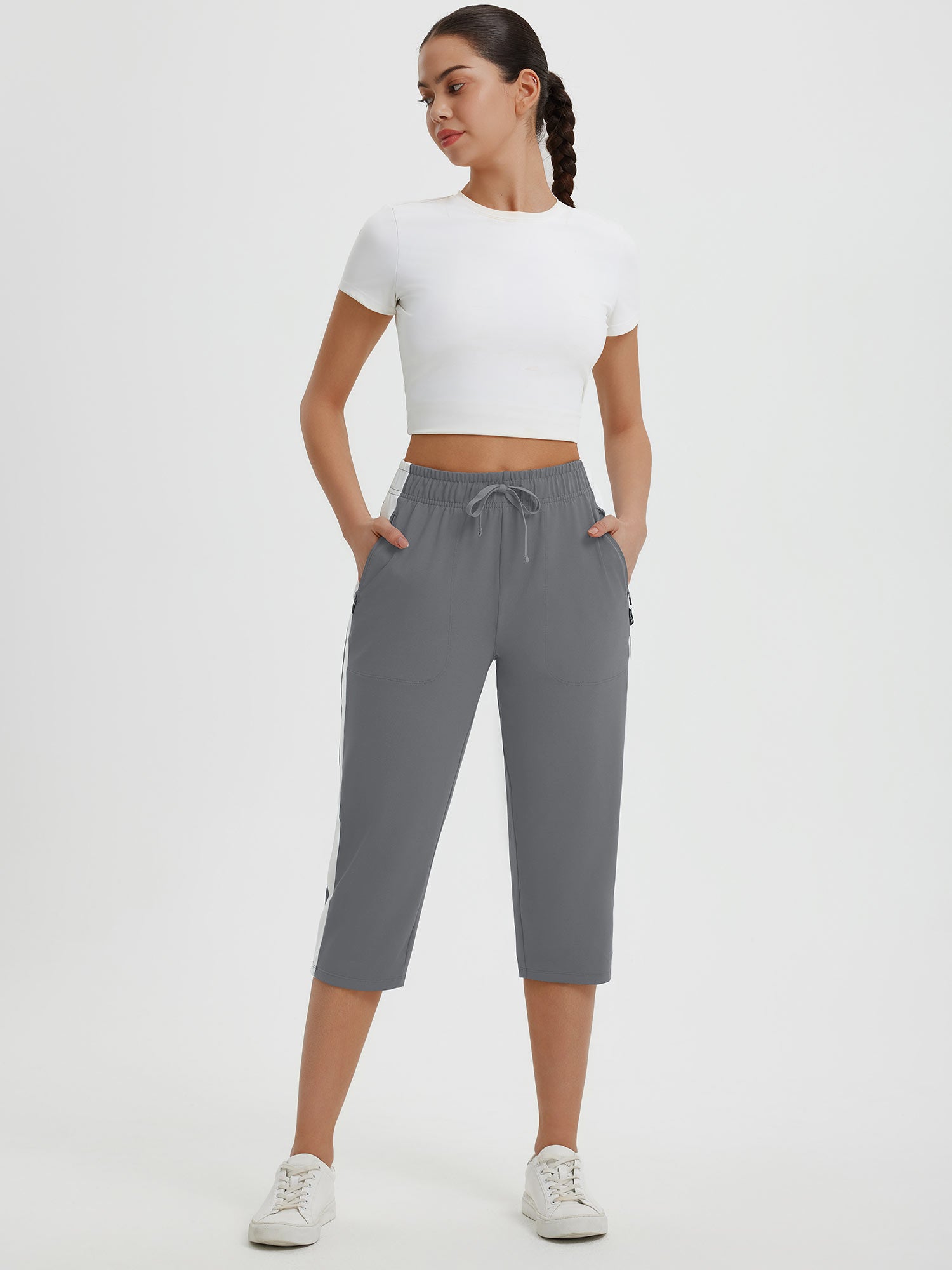 Gray women's 19" quick-dry yoga capri pants with white side stripes and drawstring waist. #color_Dark Gray