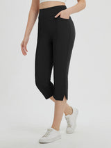 Black high-waisted capris with pockets and a 21" inseam, worn by a woman with white sneakers. #color_Black