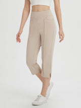 Women's high-waisted beige capri pants with a 21-inch inseam, four pockets, and split hem. #color_Khaki